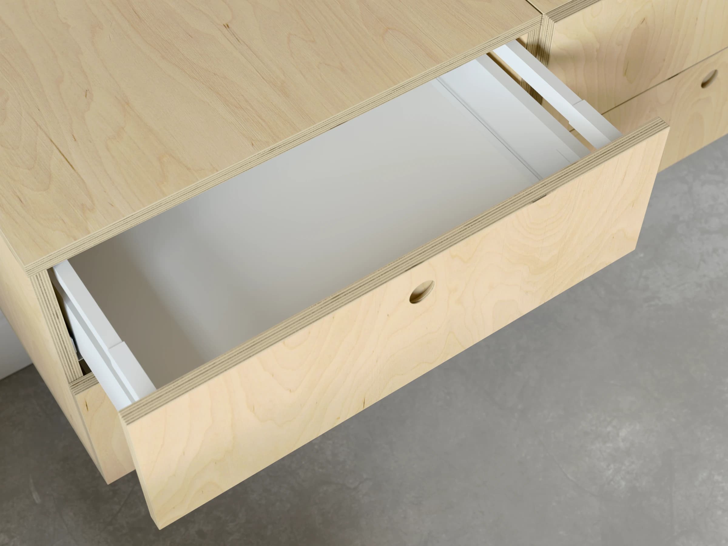 A drawer pulled open, seen from above, beside the cabinet top