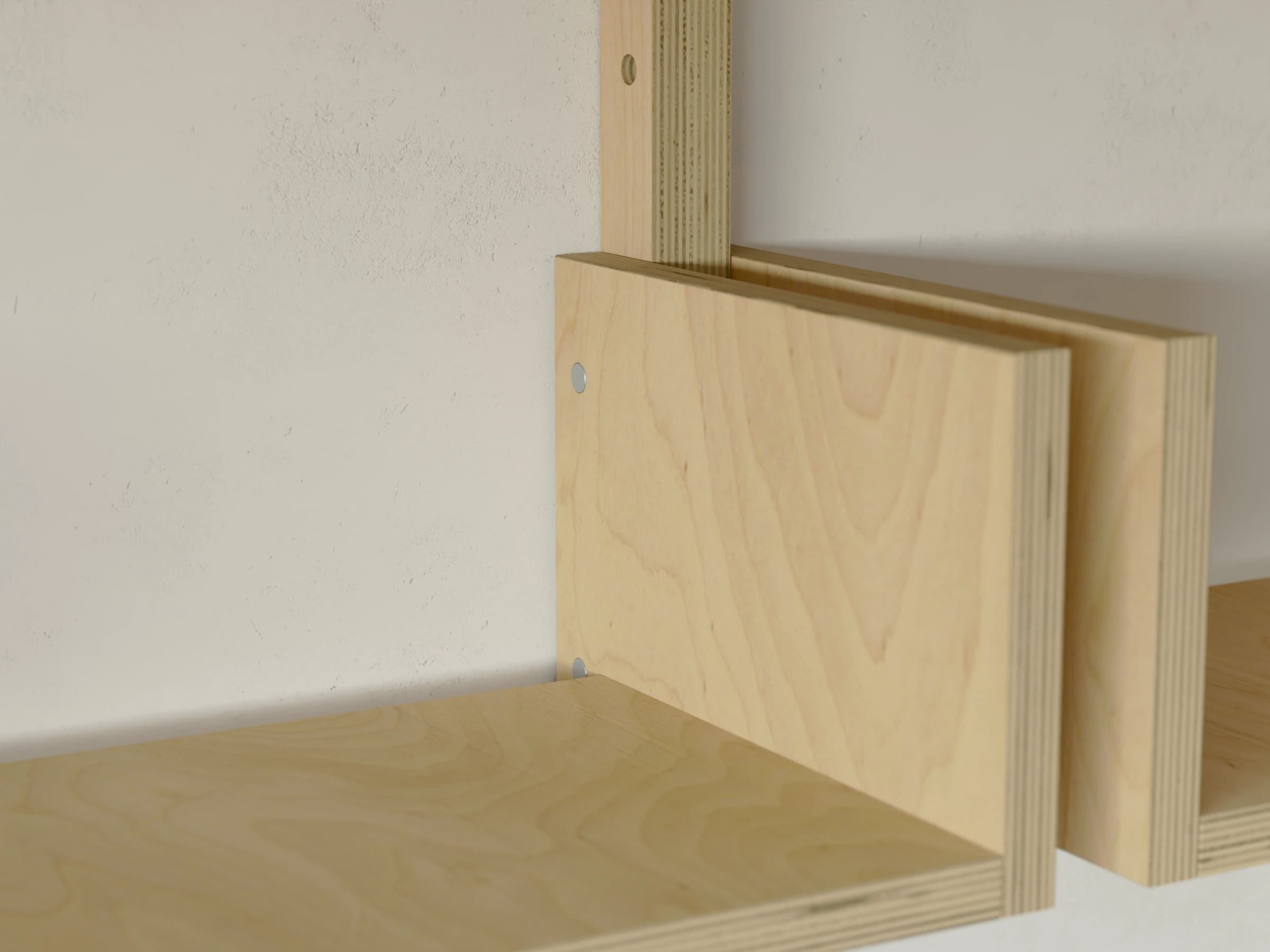 A shelf between a pair of plywood bookends, each pinned to the rail beside it