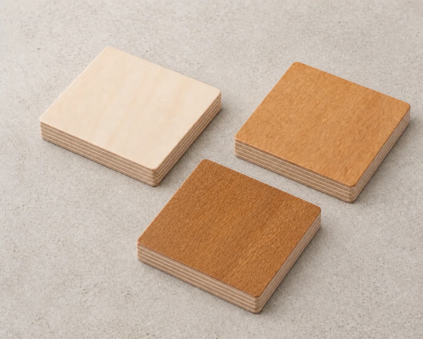 Three real light plywood finish samples showing pale and warm natural tones