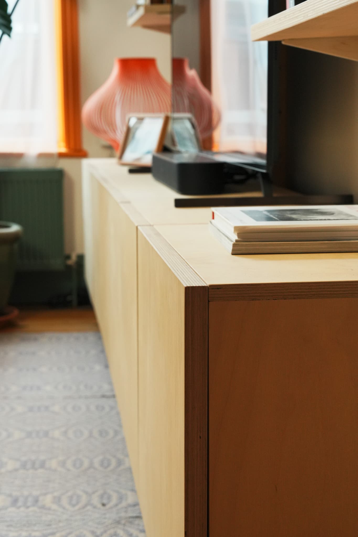 Mestra birch plywood cabinet storage with shelves and display objects in a living room