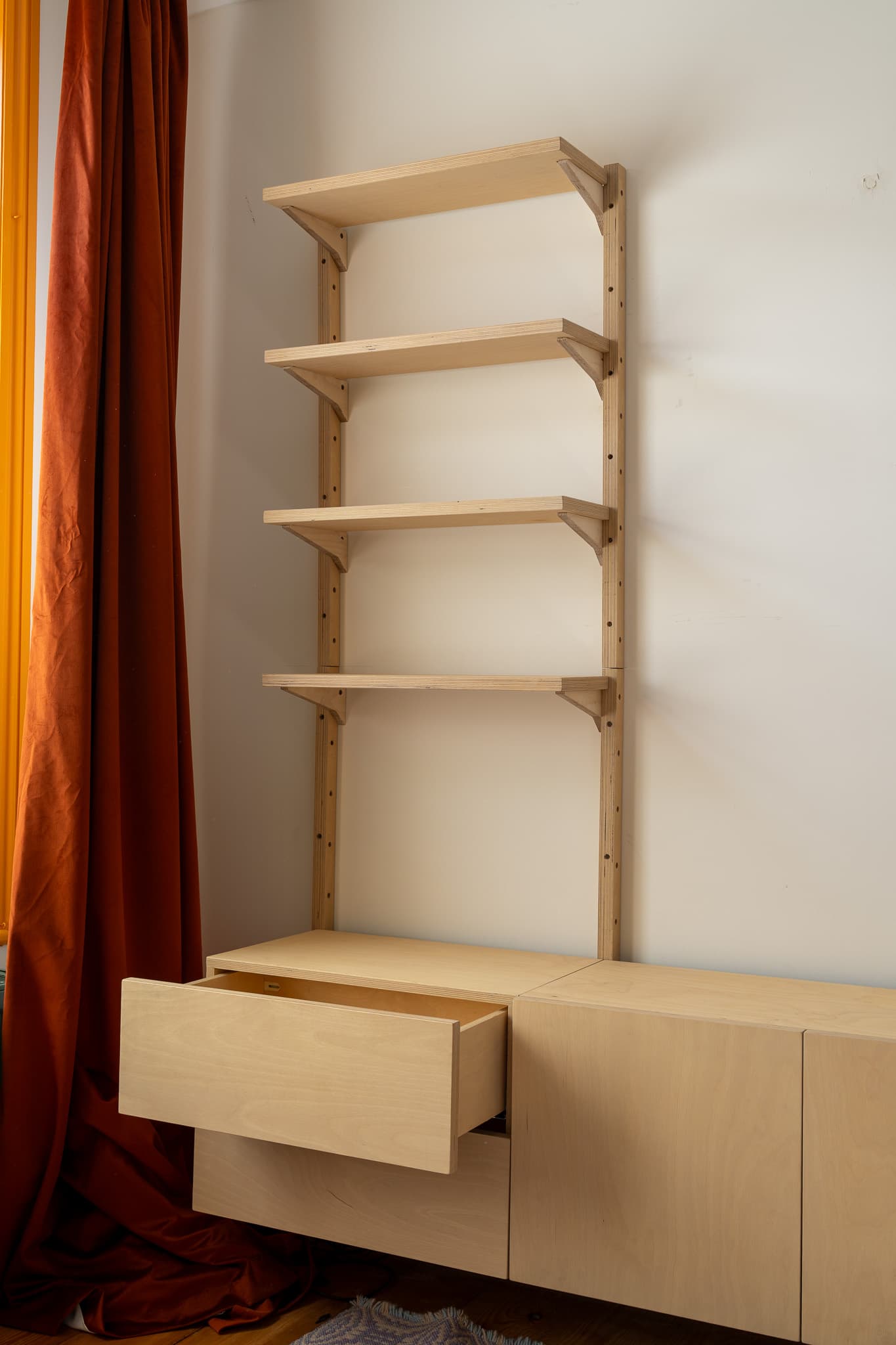 MESTRA wall-mounted birch plywood shelving with a drawer open